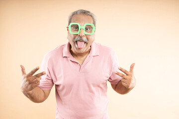 Cheerful crazy senior old man wearing funky eyeglasses shouting , Retirement life, Success in...