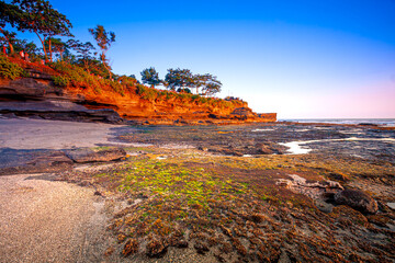 Tanah Lot Bali with sunset scenery. Image has grain or noise and soft focus when view at full resolution(Shallow DOF, slight motion blur).