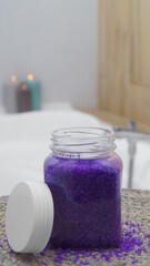 Jar with bath salt on wicker mat in bathroom