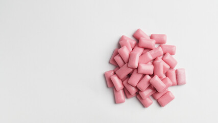 Sweet chewing gums on white background, top view. Space for text