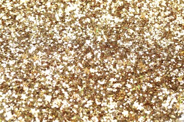 Beautiful golden shiny glitter as background, top view