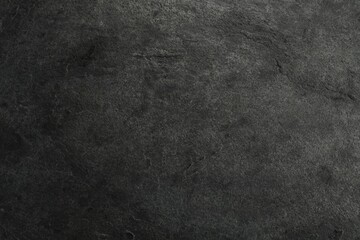 Texture of dark grey stone surface as background, closeup