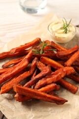 Delicious sweet potato fries and sauce on table, closeup