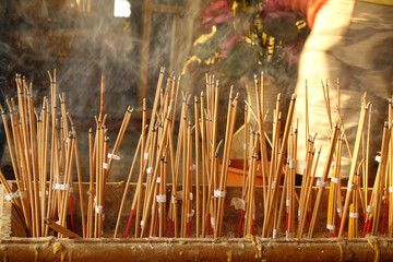 Hand lace incense on joss stick pot to make a wish,Incense that was lit to worship,Make merit for...