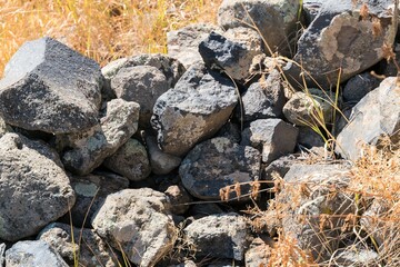 Fragment of the ruins of an ancient wall in the Caucasus mountains in autumn.