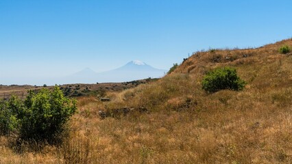 Mountain slope in autumn and foggy view of Mount Ararat.