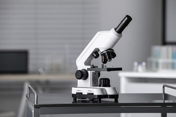 Modern medical microscope on metal table in laboratory