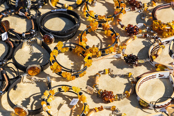 Assortment of amber bracelets laying on the counter