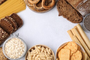 Frame made of different gluten free products on white table, flat lay. Space for text