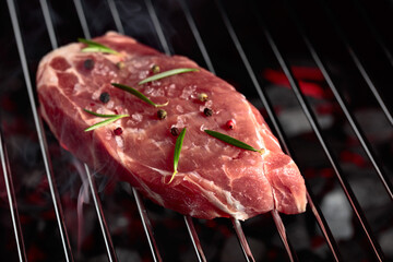 Raw steak on a grill.