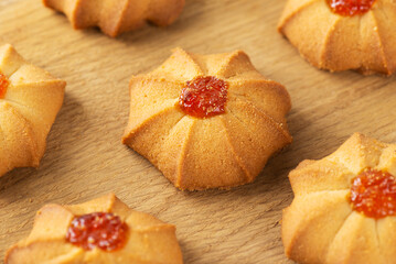 Shortbread kurabye or sweet butter cookies for Chinese New Year on wooden board.