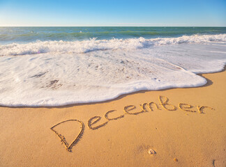December word on sea sand.