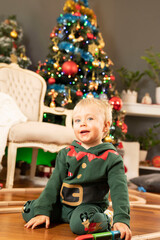 Christmas preparations. Mother and son at the table. Christmas tree in the background.