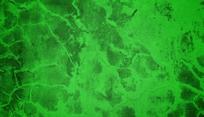 A textured green grunge background with dark patches and rough surface