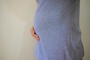 Seven months Pregnant Woman belly closeup