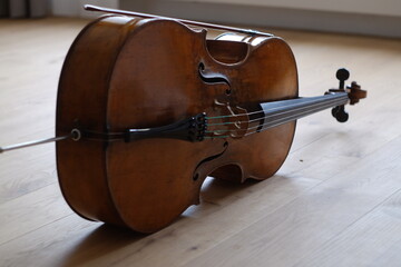 Closeup of a cello on the wooden floor. © David207/Wirestock Creators