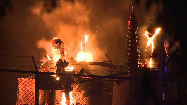 CU OF TRANSFORMER SUBSTATION ON FIRE AT NIGHT