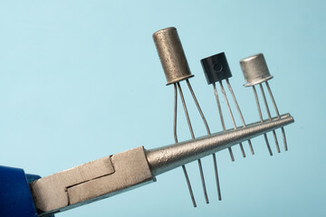 Precision pliers grips three different types of transistors
