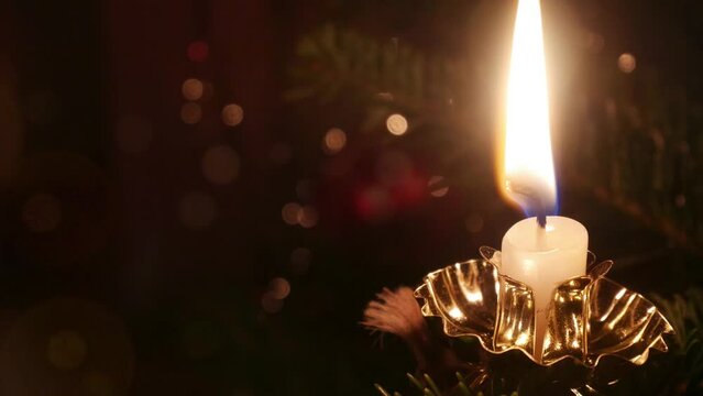 Christmas candle with bokeh light effects and copy space on the left photo animation