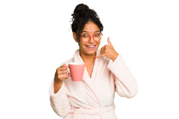 Young brazilian woman wearing a pajama holding a cup isolated showing a mobile phone call gesture with fingers.