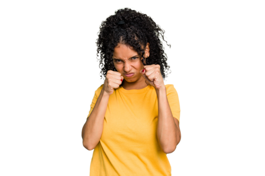 Young cute brazilian woman isolated throwing a punch, anger, fighting due to an argument, boxing.