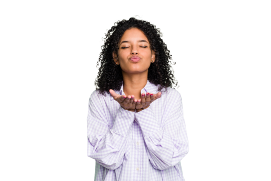 Young cute brazilian woman isolated folding lips and holding palms to send air kiss.