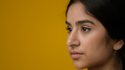 Close up portrait in studio yellow background Indian ethnic woman girl lady female suffer with...