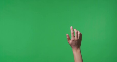 Female hand swiping to virtual screen on chroma key background, closeup