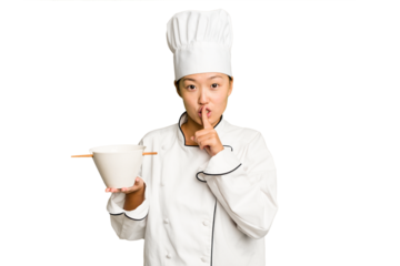 Young chef asian woman holding a bowl of ramen isolated keeping a secret or asking for silence.