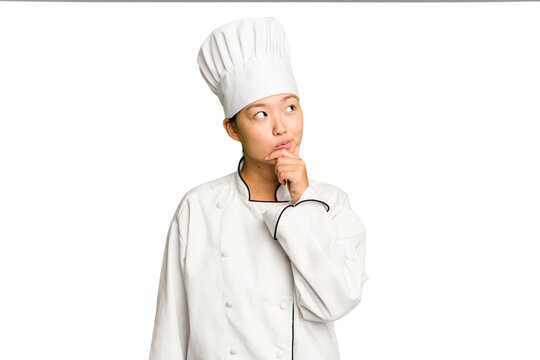 Young asian cook woman isolated looking sideways with doubtful and skeptical expression.
