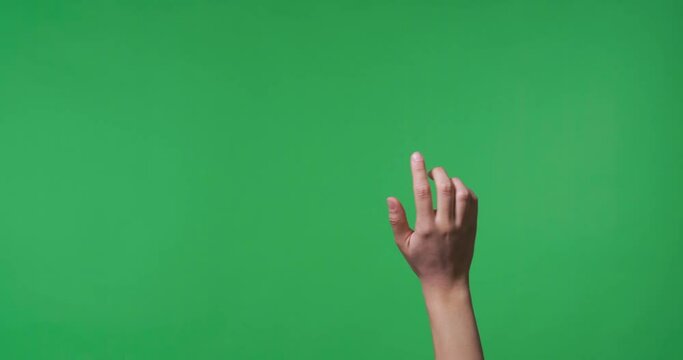 Female hand swiping to virtual screen on chroma key background, closeup