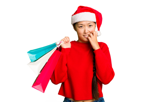 Young asian woman shopping a christmas presents isolated Young asian woman shopping a christmas presents isolated biting fingernails, nervous and very anxious.