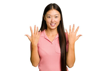 Young Asian woman isolated showing number ten with hands.