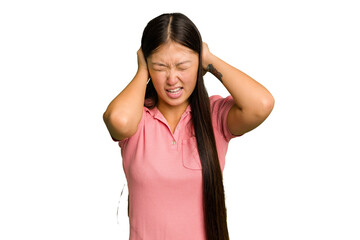 Fototapeta premium Young Asian woman isolated covering ears with hands trying not to hear too loud sound.