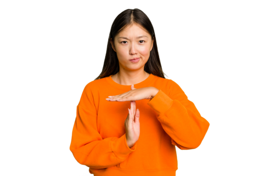 Young Asian woman isolated showing a timeout gesture.