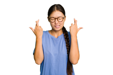 Young Asian woman isolated crossing fingers for having luck