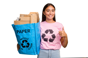 Young caucasian woman holding a recycling bag full of paper to recycle isolated smiling and raising thumb up