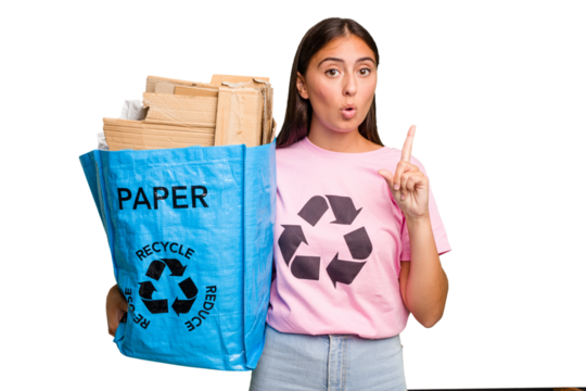 Young caucasian woman holding a recycling bag full of paper to recycle isolated having some great idea, concept of creativity.