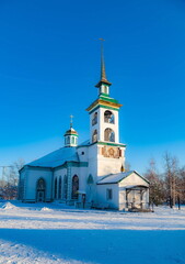 Fototapeta na wymiar The building of the Orthodox church against the blue sky in winter. Russia. Ural. Polevskoy