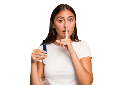 Young caucasian woman holding a electronic cigarette keeping a secret or asking for silence.