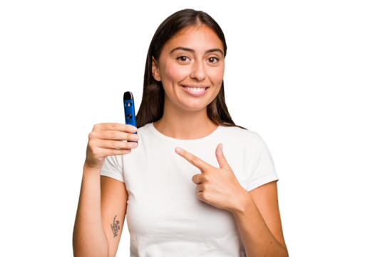 Young caucasian woman holding a electronic cigarette smiling and pointing aside, showing something at blank space.