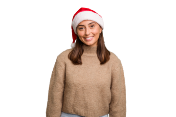 Young caucasian woman celebrating christmas wearing a santa hat isolated happy, smiling and cheerful.