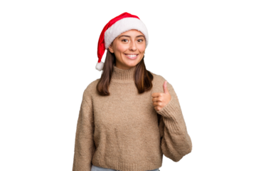 Young caucasian woman celebrating christmas wearing a santa hat isolated smiling and raising thumb up