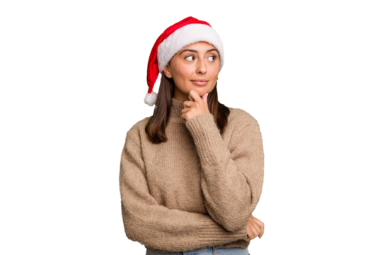 Young caucasian woman celebrating christmas wearing a santa hat isolated looking sideways with doubtful and skeptical expression.