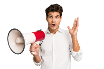 Young caucasian man holding megaphone isolated surprised and shocked.