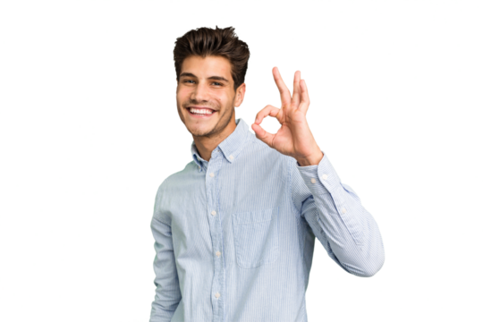 Young caucasian handsome man isolated winks an eye and holds an okay gesture with hand.