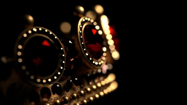 Golden crown with rubies on black background 3D 4K looped animation with copy space. Sparkling royal corona. Close-up.