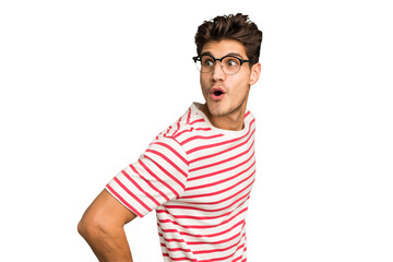 Young caucasian handsome man isolated looks aside smiling, cheerful and pleasant.