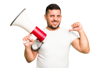 Young caucasian man holding a megaphone isolated feels proud and self confident, example to follow.
