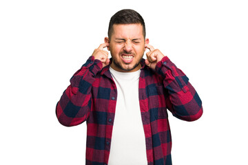 Young caucasian man isolated covering ears with fingers, stressed and desperate by a loudly ambient.